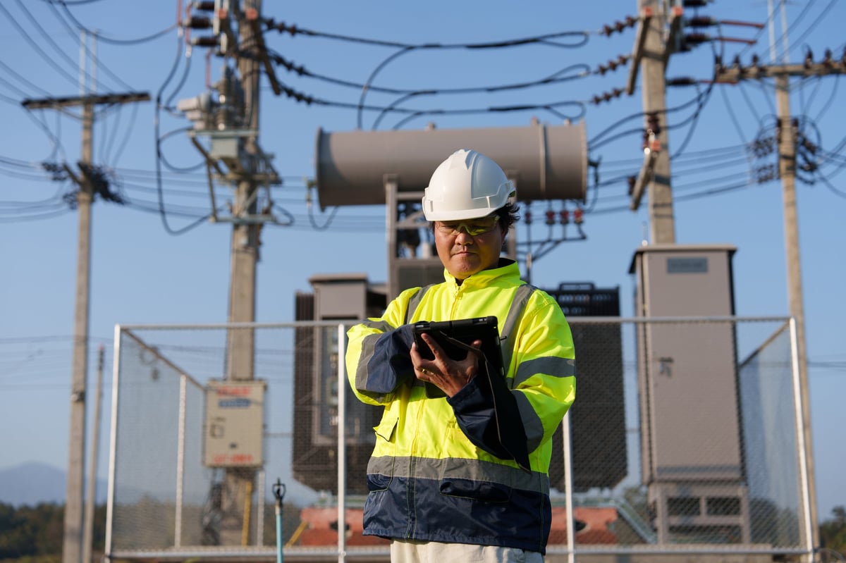 Technician inspecting electrical equipment on a commercial site